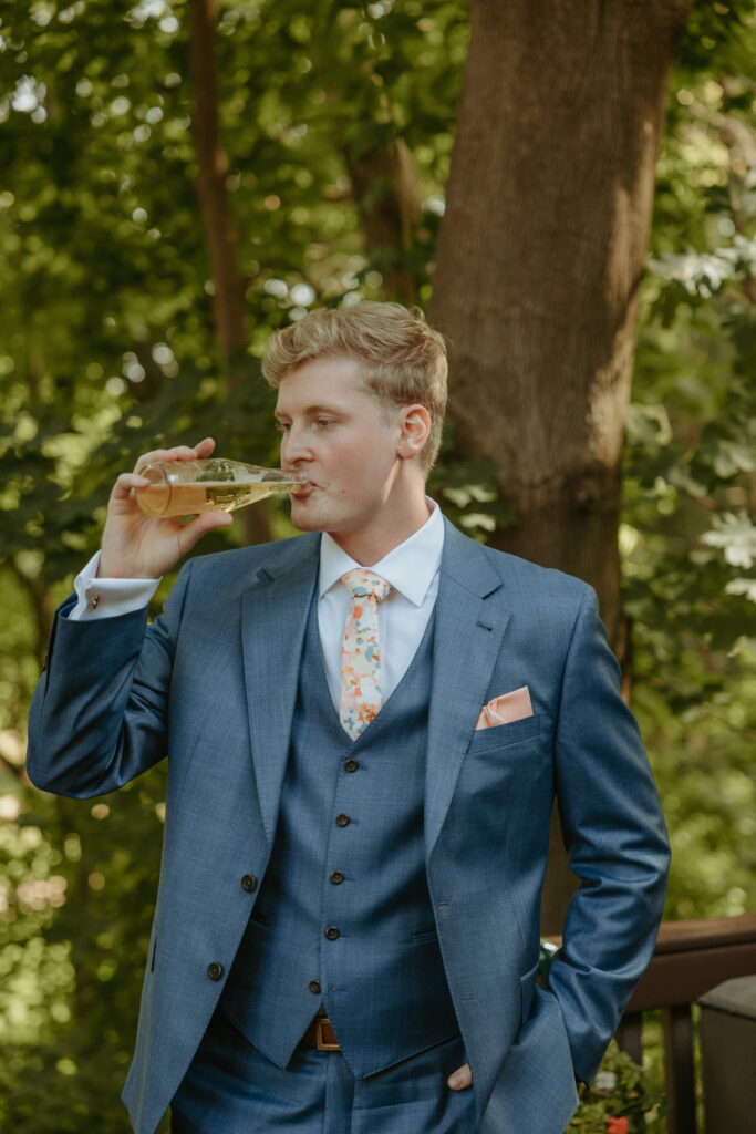 groom drinking a beer during getting ready