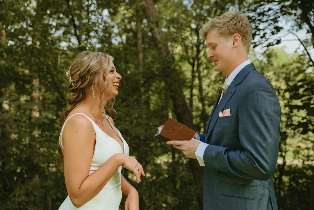 couple reading their vows during first look surrounded by nature in appleton 