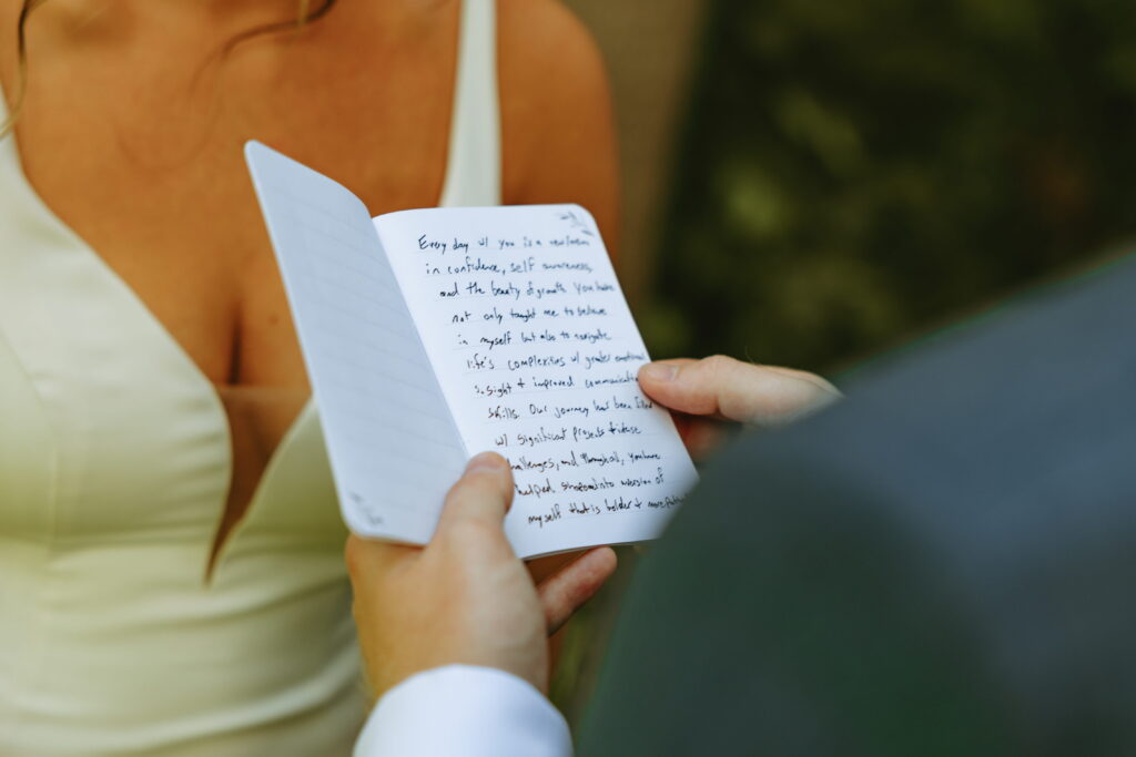 close up of groom reading his vows on wedding day
