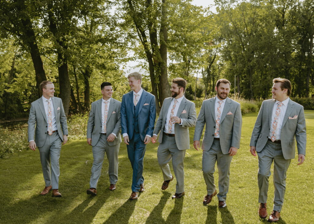 groomsmen walking at butte des morts country club