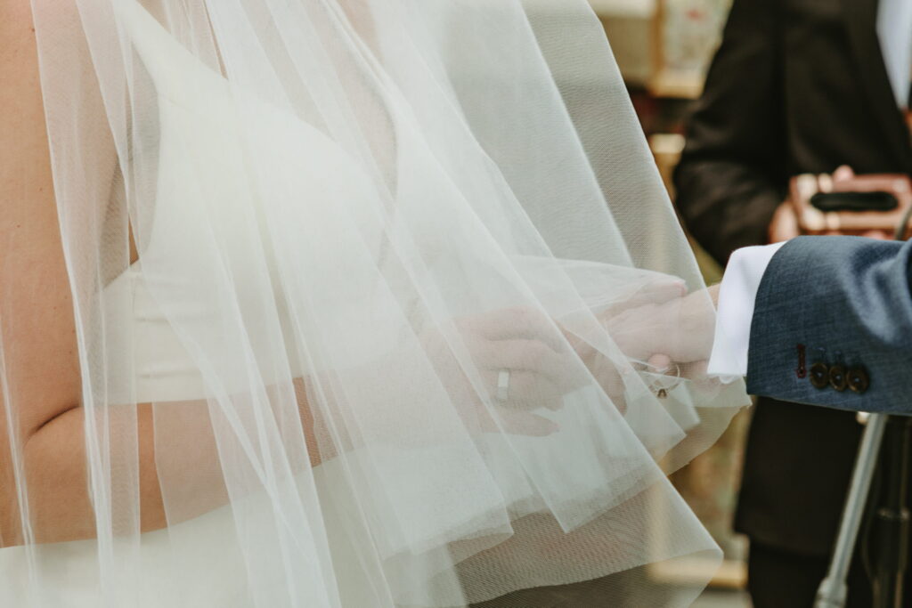 exchanging rings at wedding ceremony overlooking golf course