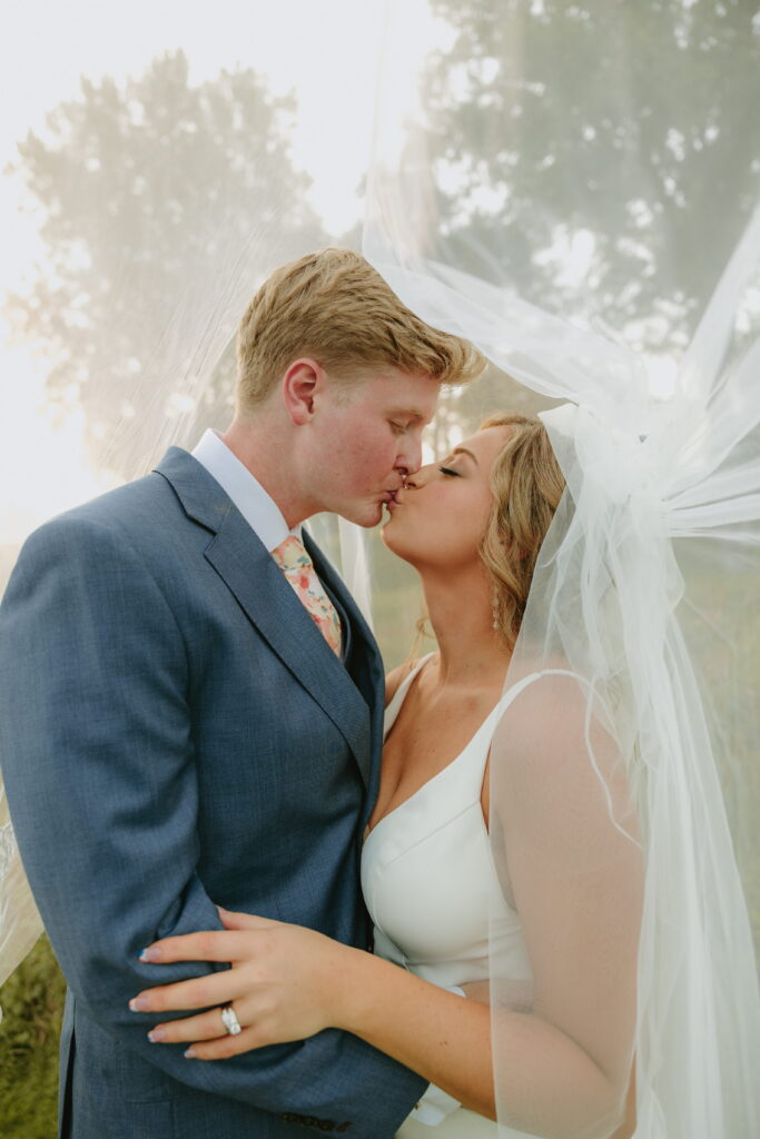 golden hour couple wedding portraits under veil