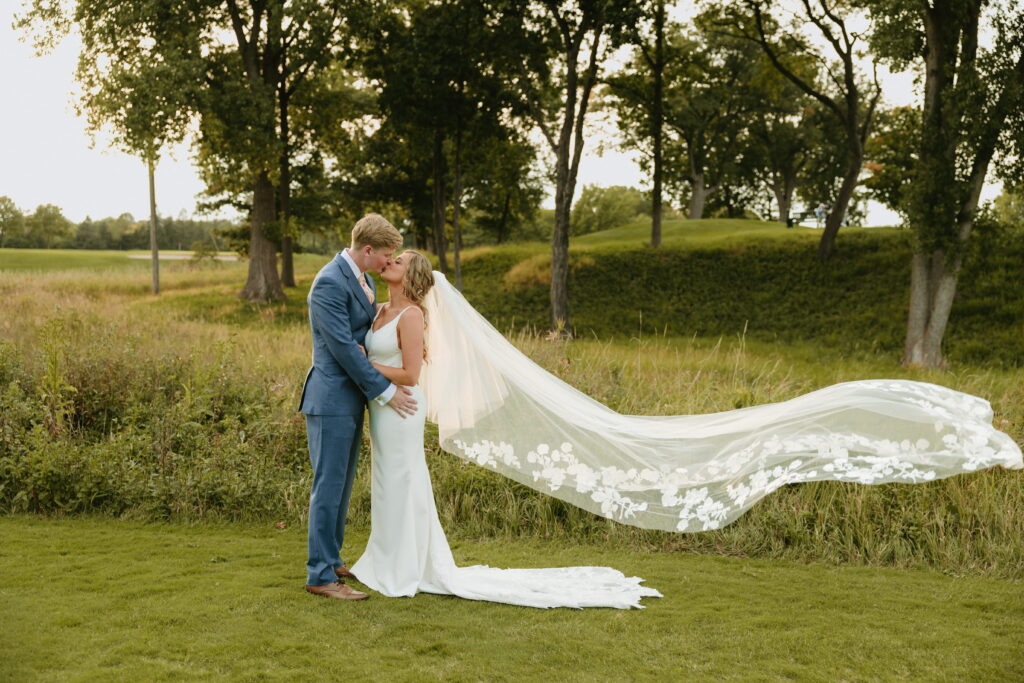 golden hour couple wedding portraits veil in air