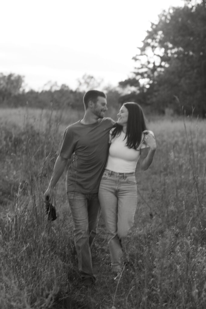 couple popped champagne for their engagement photos in a field in wisconsin