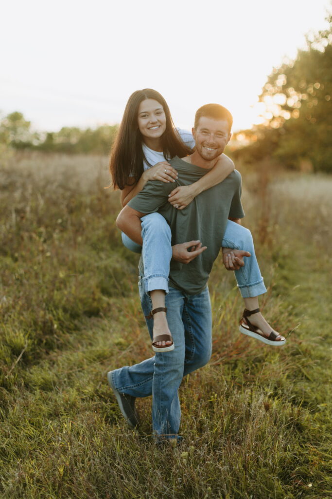 couple piggy back ride engagment shoot - How to include your dog in your adventurous engagement photos