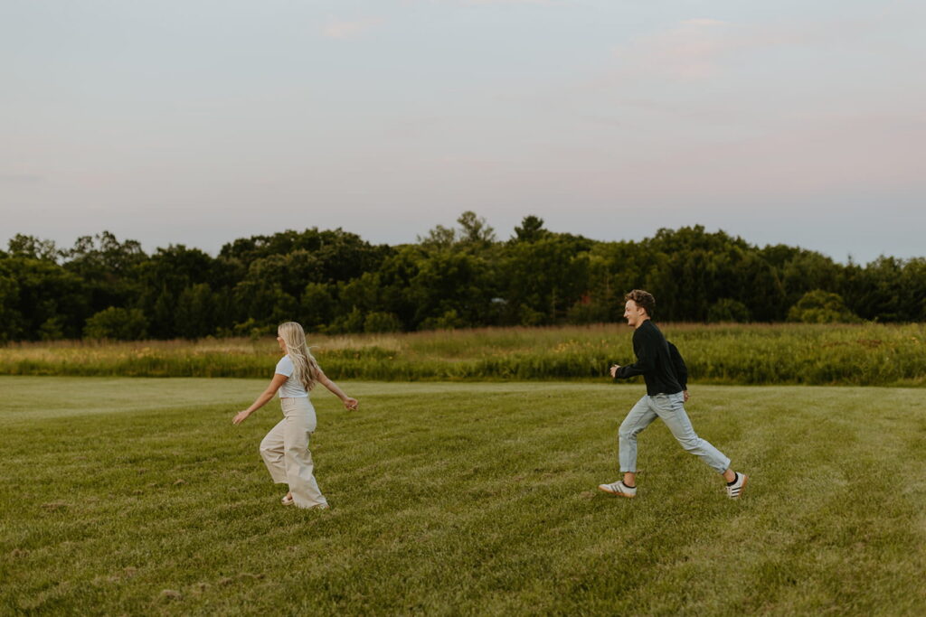 couple running for engagement pictures at Retzer Nature Center