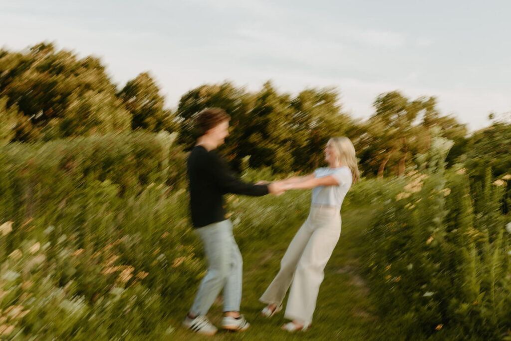 couple holding hands and spinning around